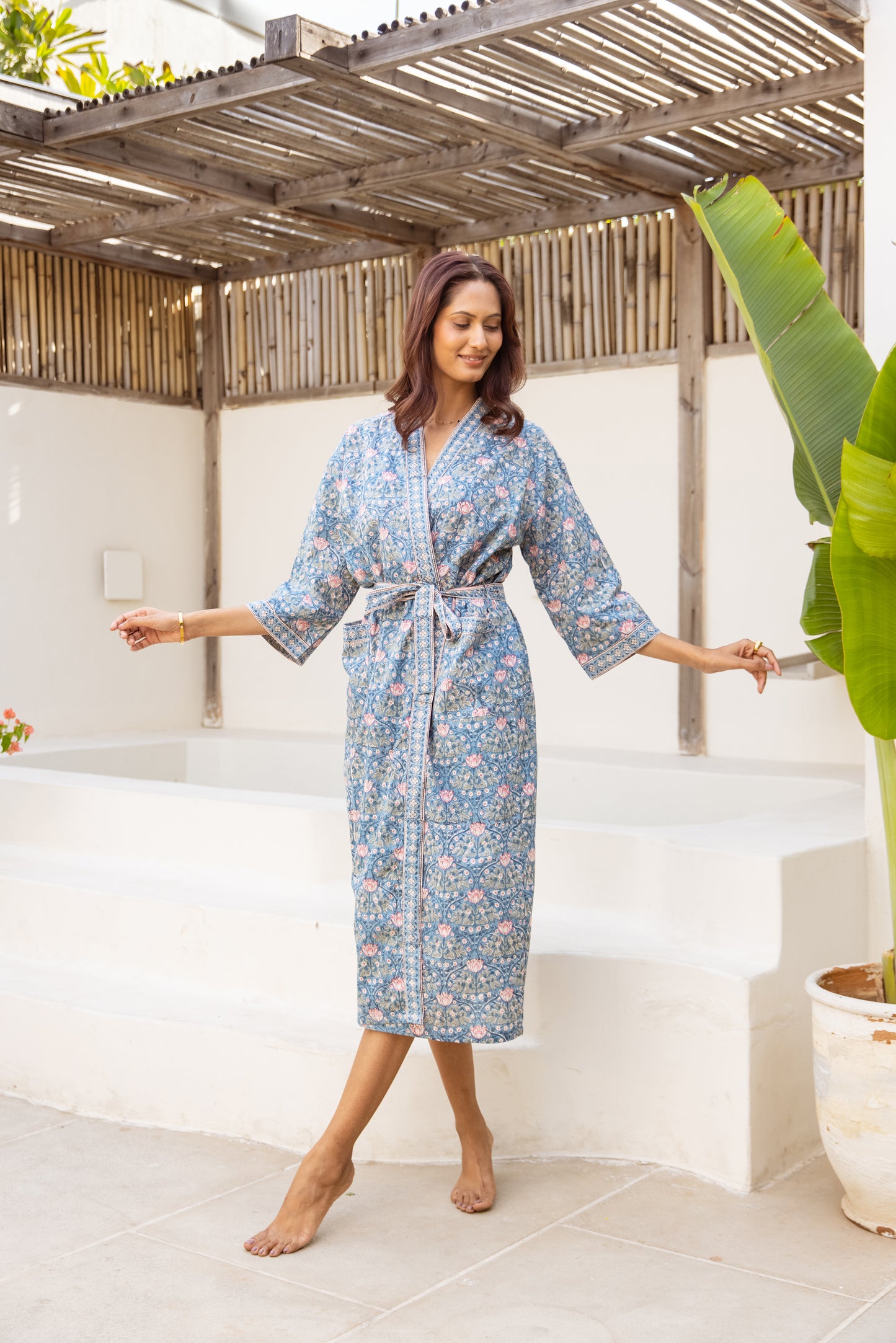 Woman wearing blue floral cotton robe in outdoor setting