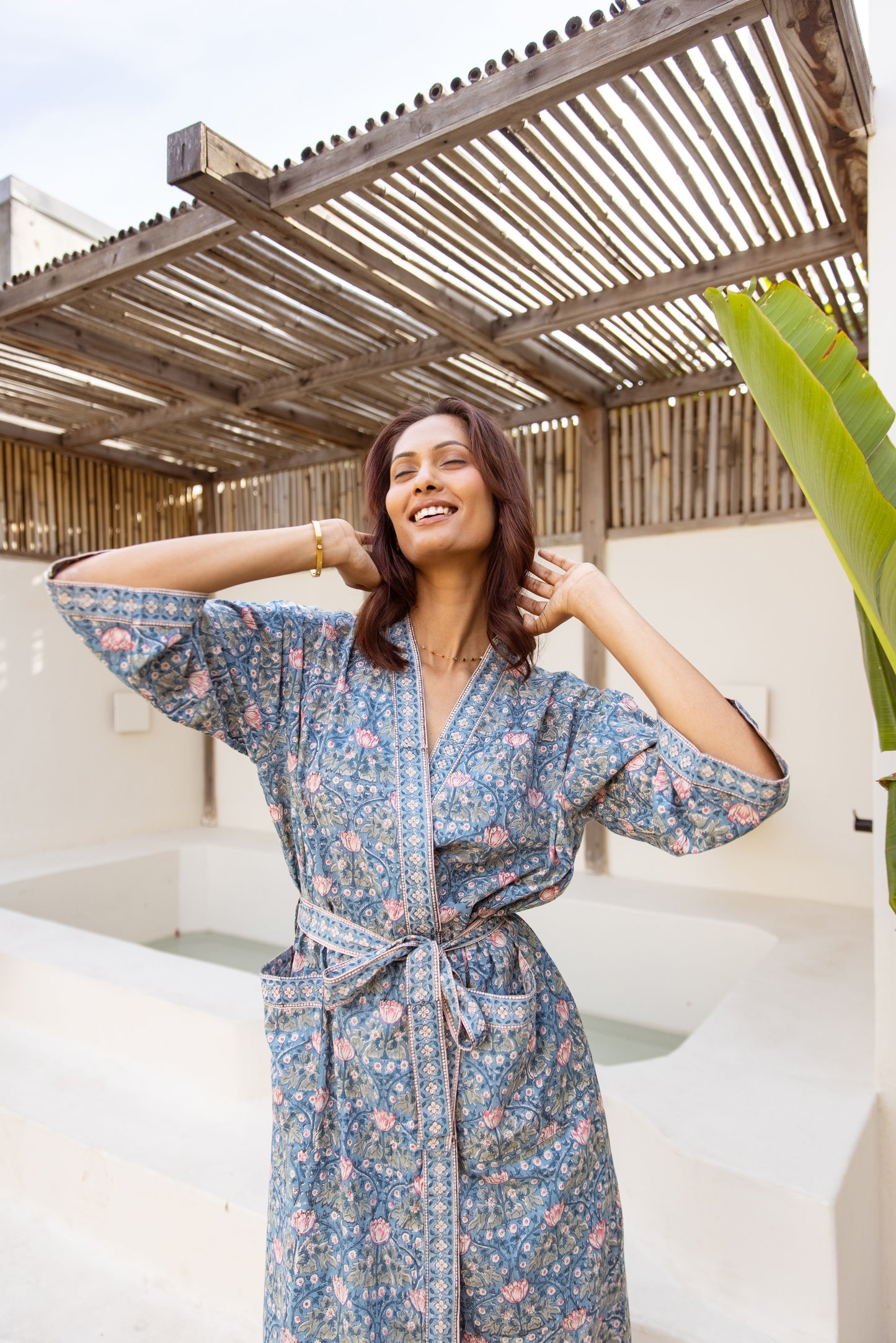 Woman posing in breathable cotton robe under natural light