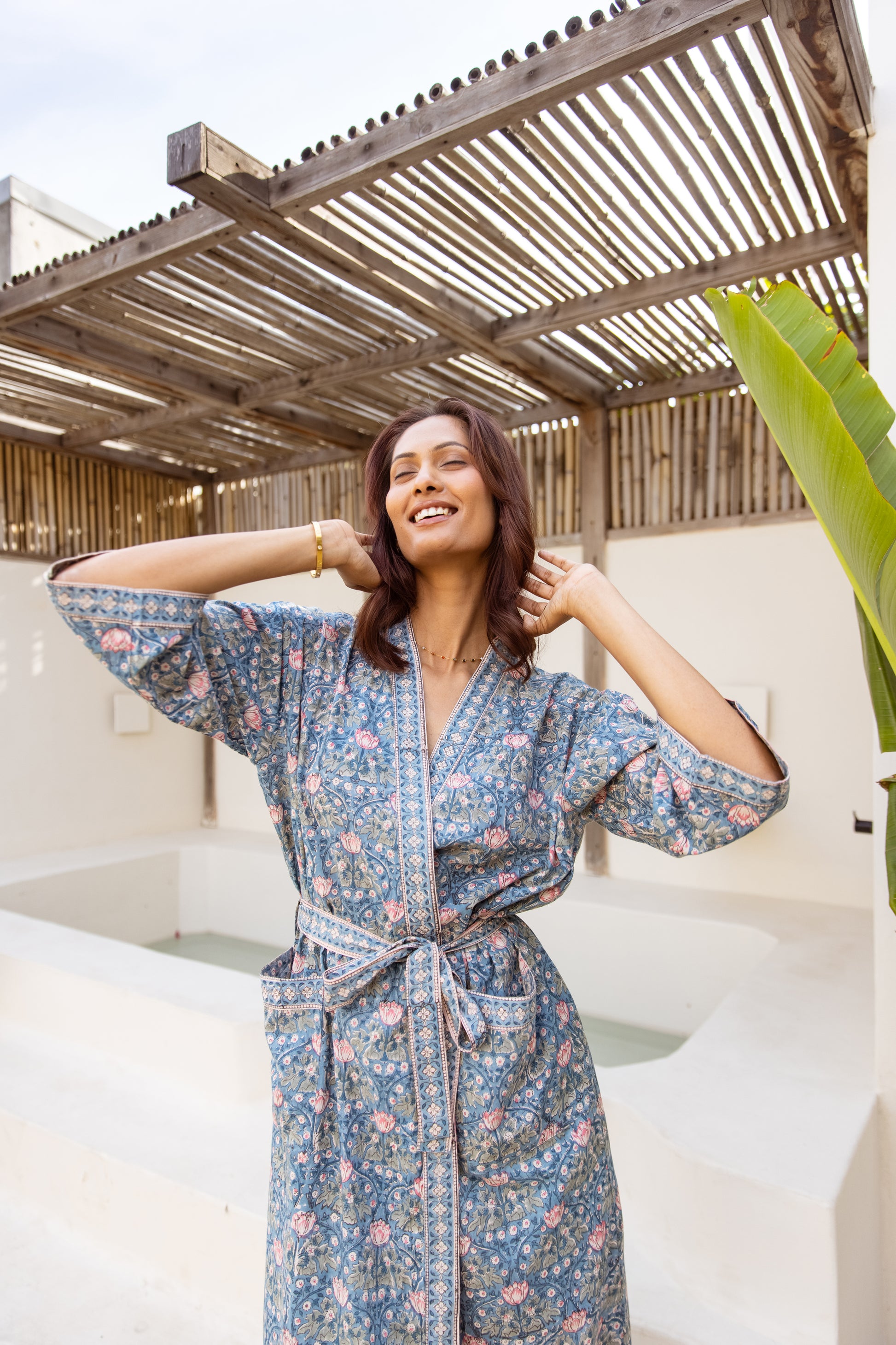 Woman posing in breathable cotton robe under natural light