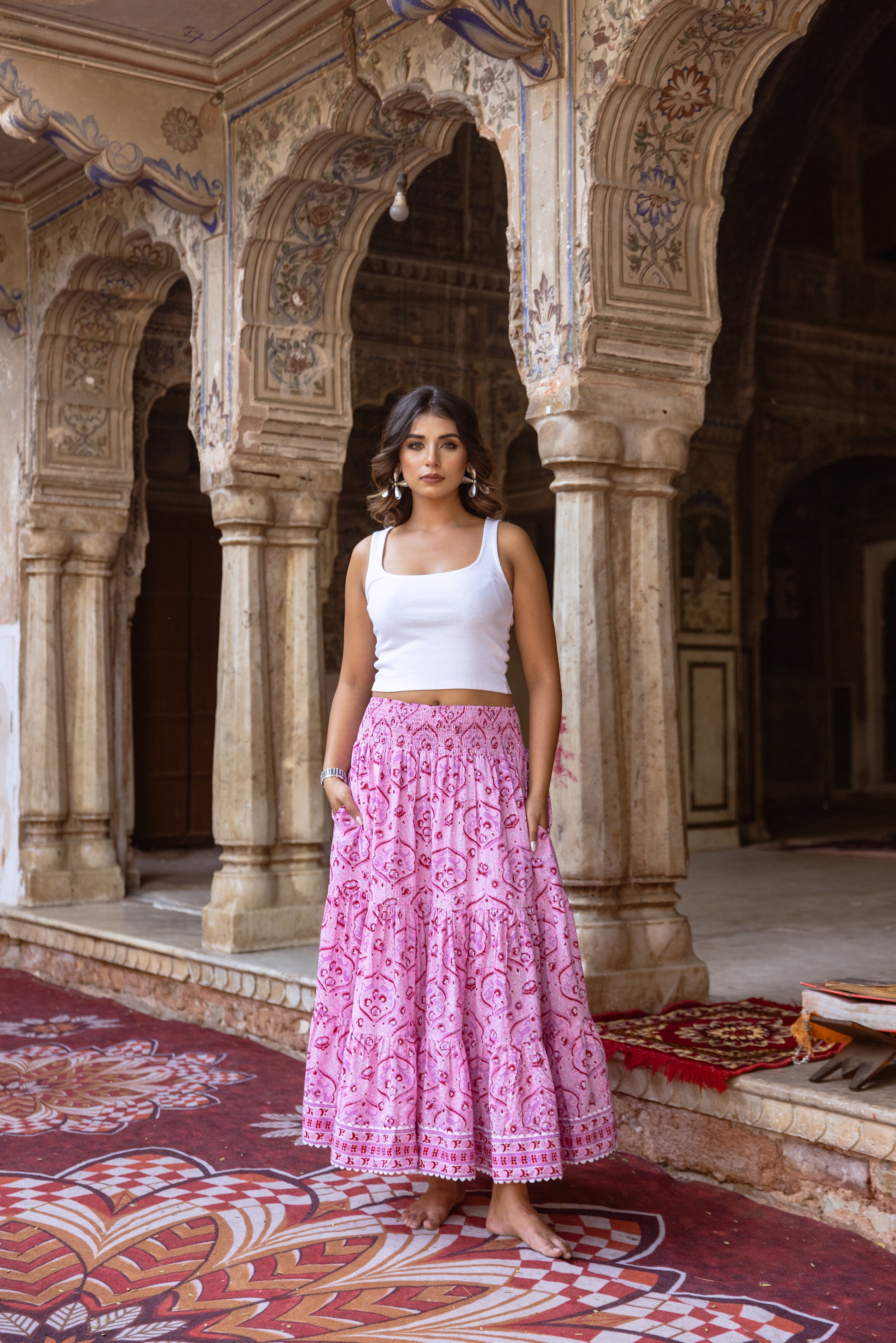 Model wearing a pink floral long cotton skirt in hand block print