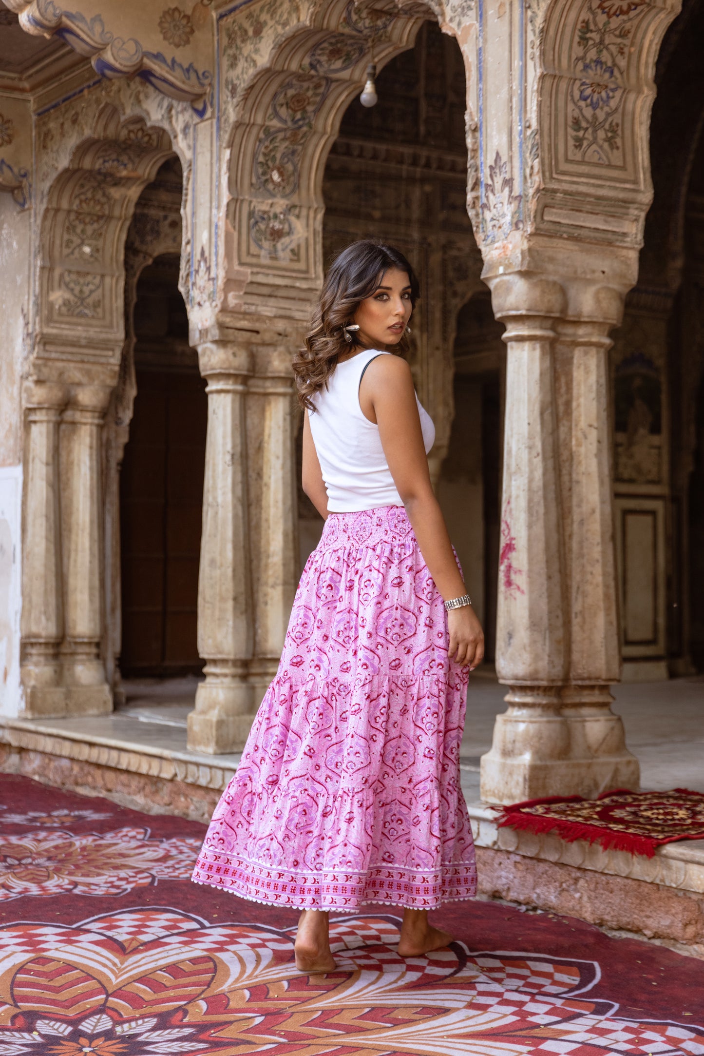 Back view of pink cotton maxi skirt with smocked waistband