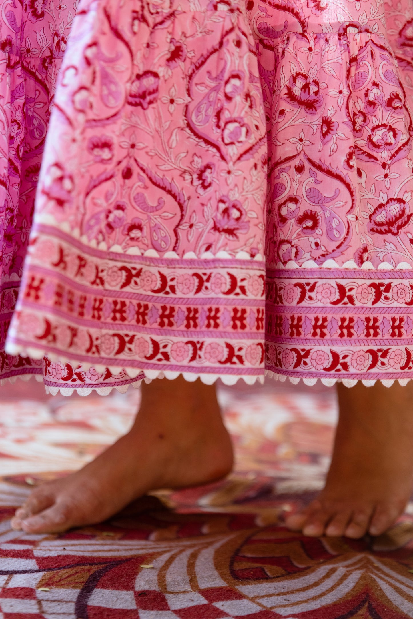 Close-up of contrast hem on pink floral tiered skirt