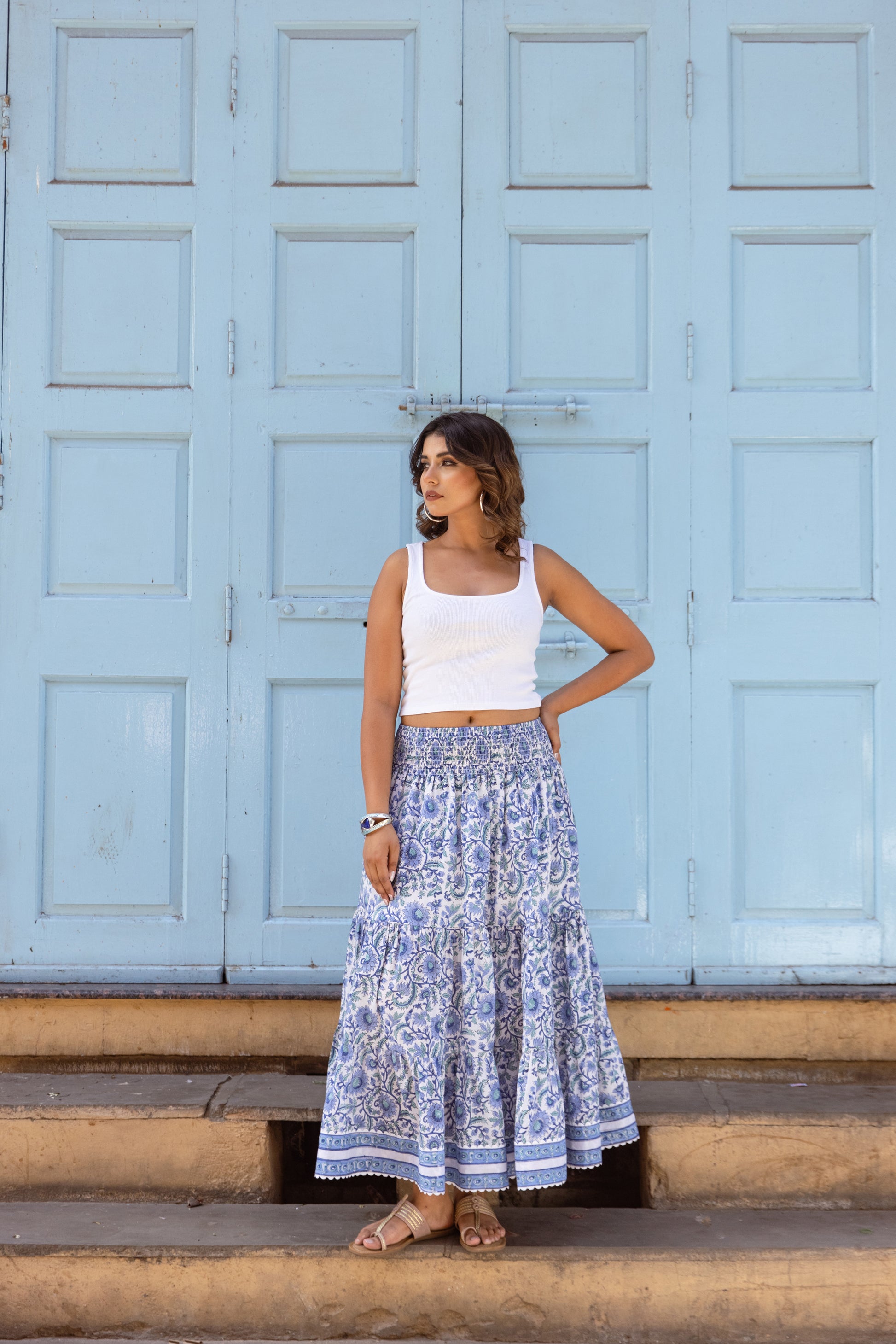 Woman wearing an azure blue long cotton skirt with hand block print