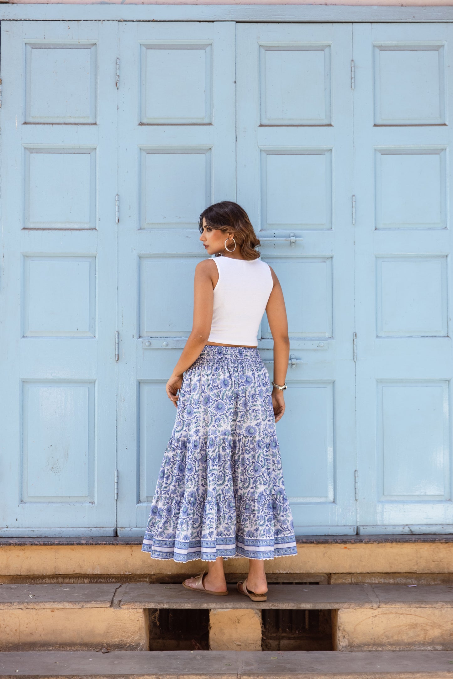 Back view of azure blue cotton maxi skirt with smocked waistband