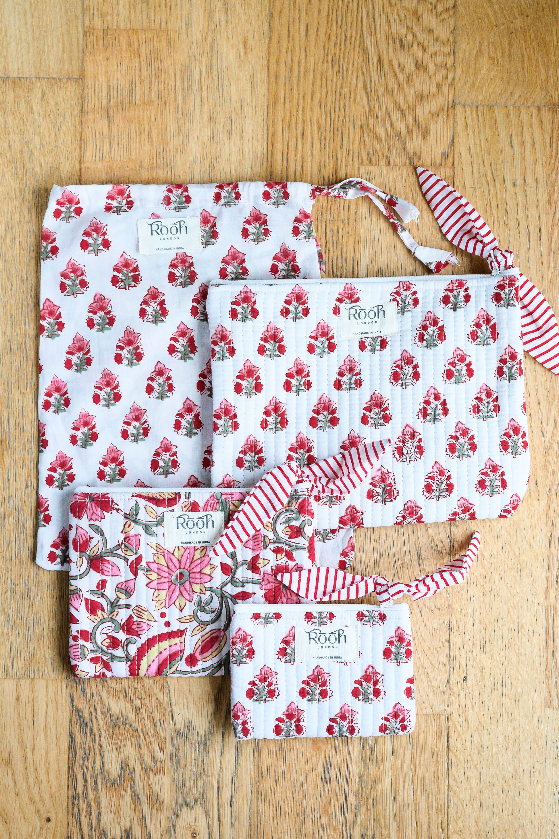 Sustainably handcrafted Crimson Bloom quilted pouch set from India.