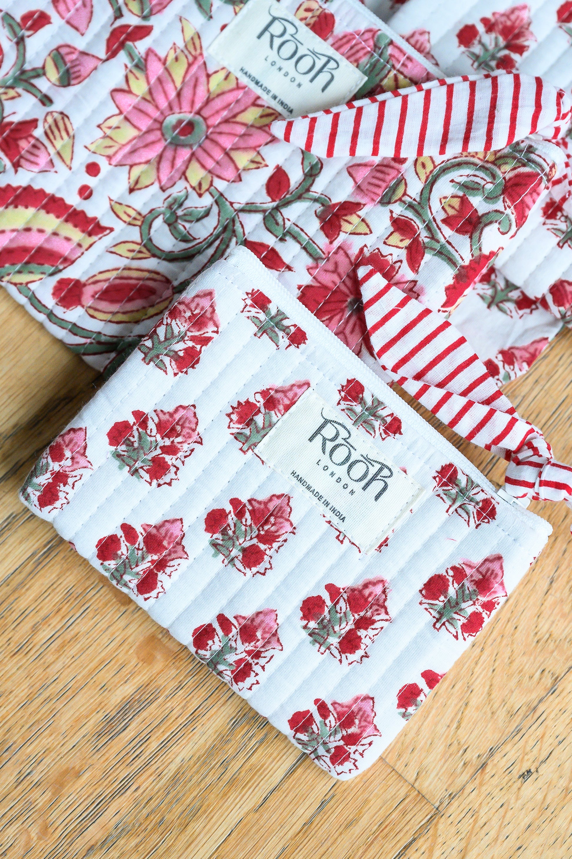 Handcrafted quilted cosmetic pouches in Crimson Bloom print.
