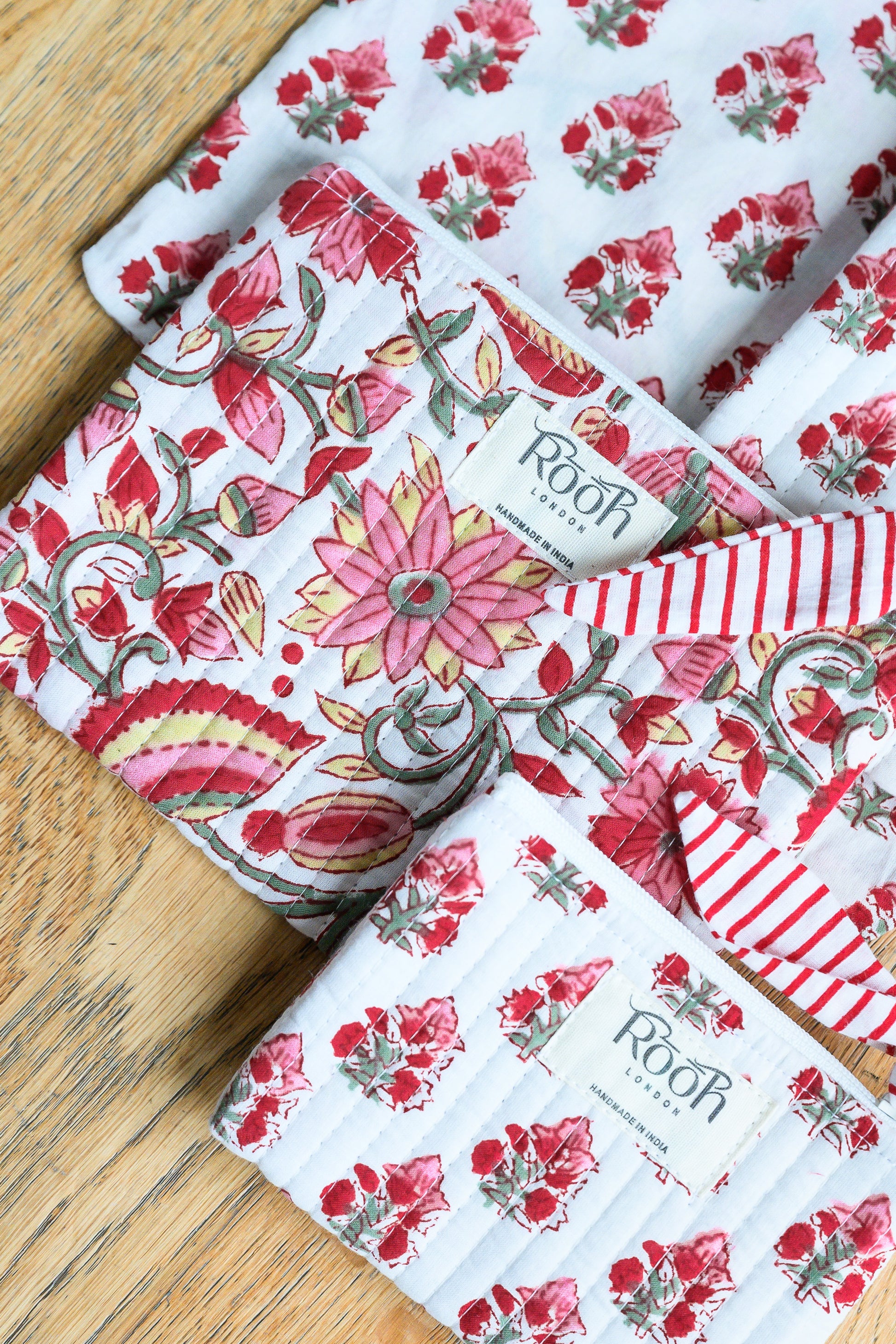 Crimson Bloom floral quilted travel and cosmetic pouch set.