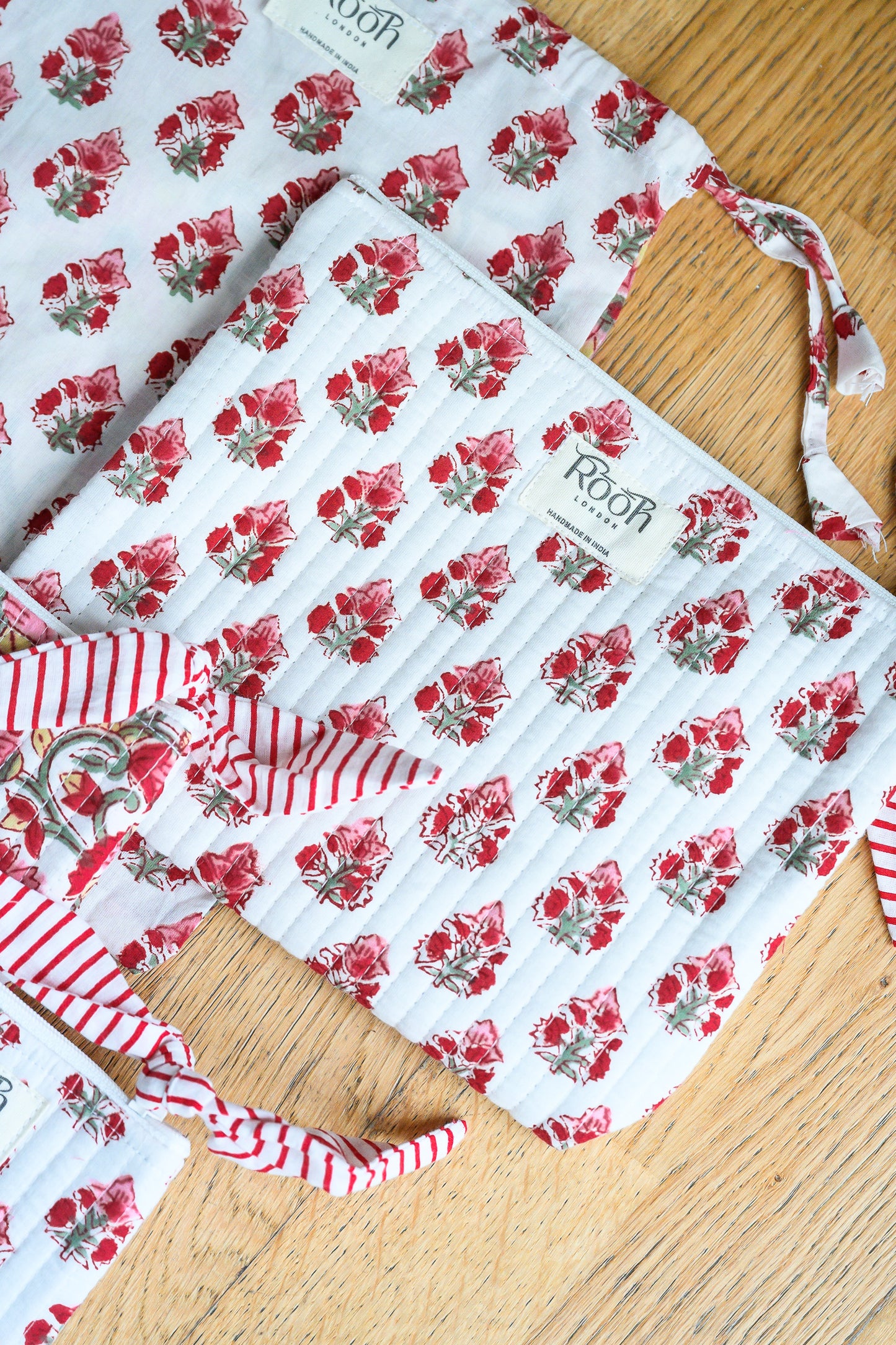 Lightly quilted Crimson Bloom travel pouch set with cotton lining.